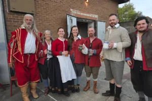 English Civil War re-enactors enjoying a drink.
