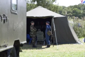 Two reenactors talking by a tent.