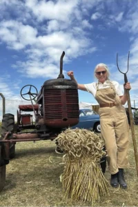A member of the Suffolk Woman's Land Army with their tractor