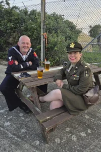 Two re-enactors enjoying a drink after a long day at the Suffolk Aviation Heritage Museum's annual show.